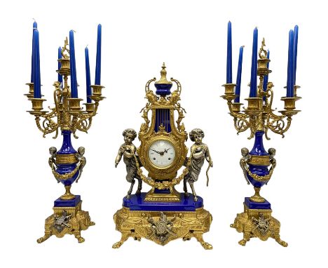 A 20th century continental gilt metal Lyre mantle clock with a pair of matching six light candelabra, spring driven movement 