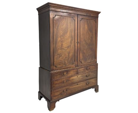 George III mahogany linen press, projecting cornice over two figured doors enclosing five linen slides, the lower section fit