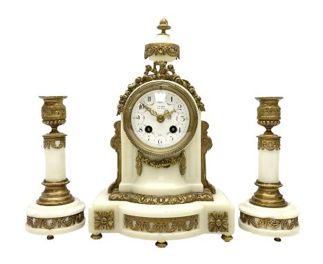 An early 20th century white marble mantle clock in a break front case with an arched top and finial, gilded scroll work to th