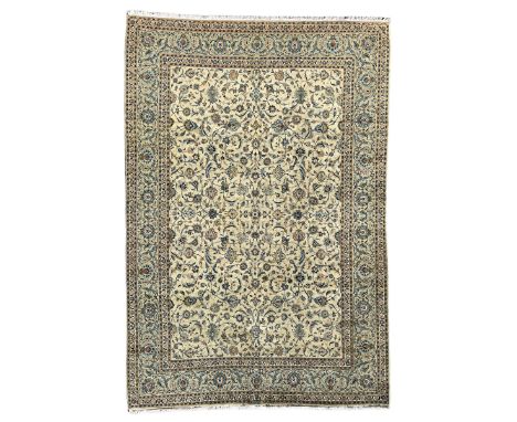 Persian Kashan carpet, light sage green ground, the field decorated all-over with interlaced foliate and plant motifs, repeat