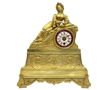 A Napoleon III c1860 French Ormolu mantle clock with a reclining figure of an oriental lady on a stepped plinth, base with sp