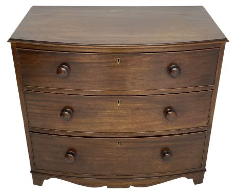 Small early 19th century figured walnut bow front chest, fitted with three graduating drawers with turned handles, with shape