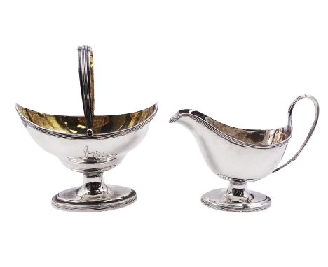 George III silver sugar basket and cream jug, the basket of navette form with strap border to rim, swing handle and gilt inte