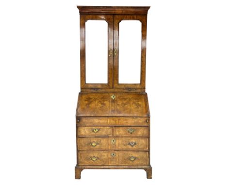 George II figured walnut bureau bookcase, the bookcase with cavetto moulded cornice over two mirror glazed doors, the bevelle