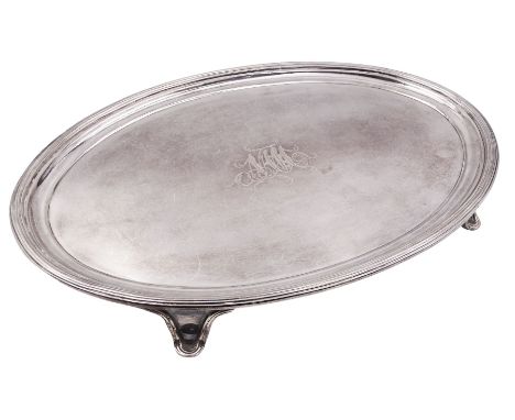 George IV silver card waiter or tray, of oval form with reeded rim and engraved monogram to centre, upon four splayed feet, h