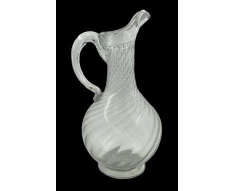 Early 19th century Continental soda glass jug, the wrythen bulbous body with thick rim and lip and hollow curved handle, upon