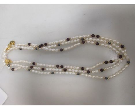 Three pearl necklaces, interspaced with 14 carat gold, garnets or haematite (3)  
