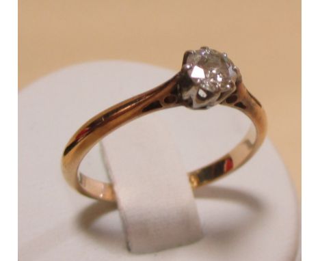 A diamond solitaire ring, the round brilliant cut diamond, estimated 0.3cts, claw set in white metal to a yellow metal band s