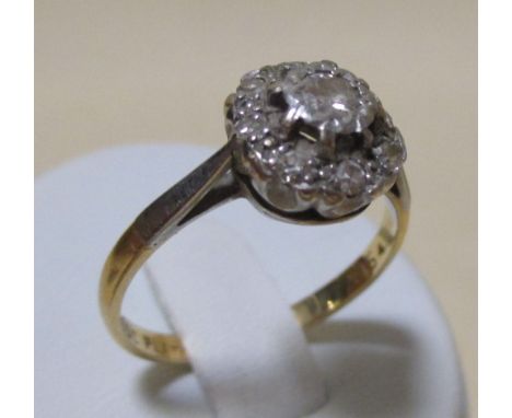 An 18ct and platinum diamond cluster ring, an 18ct four stone diamond ring, a 10k diamond set horseshoe ring and a 9ct sapphi