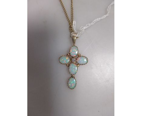 A gold mounted opal cross on chain  