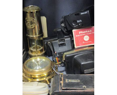 A quantity of cameras, a miners lamp and a brass cased ships wheel style barometer  