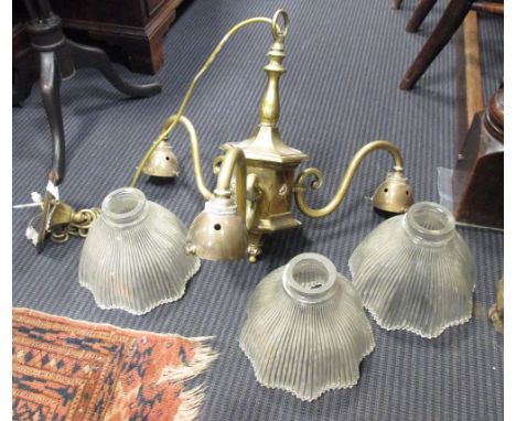 A brass three branch ceiling light with glass shades  