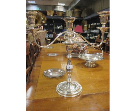 A pair of electroplate three light candelabra, an electroplate egg cruet frame and a pierced cake basket (3)  