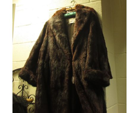 A mink fur coat, together with two other fur coats and a silk dress  