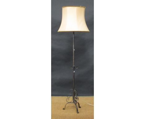An adjustable wrought iron standard lamp on tripod base, and a Victorian scroll leg footstool (2)  