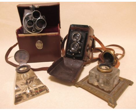 A leather cased Rolliflex camera, another and two glass inkwells  