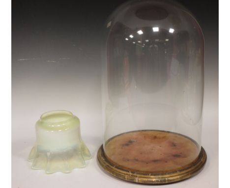 A late Victorian glass dome on circular stand, 51cm high, 30cm diameter, and an opalecent glass light shade and a wall bracke