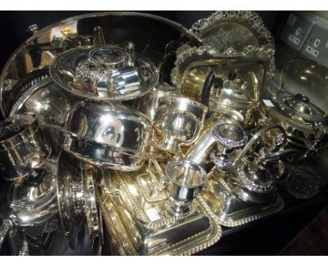 A shelf of electroplate including entree dishes, tea kettle, tea urn etc  