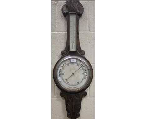 A 1940's oak cased aneroid barometer and a 19th century copper warming pan  