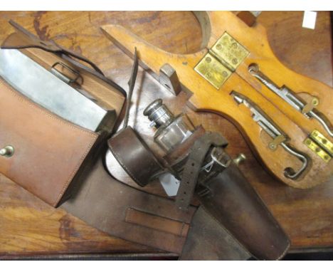 A leather cased Dixon's electroplate hip flask, leather cased pewter sandwich box and a set of boot tools within boot jack ca