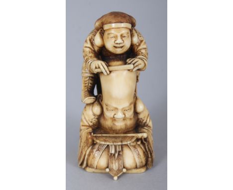 AN UNUSUAL GOOD QUALITY STAINED IVORY OKIMONO OF FUKUROKUJU & DAIKOKU, the latter atop a ladder and shaving the former’s bald
