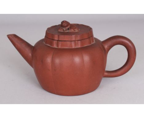 A 19TH CENTURY CHINESE YIXING FLUTED POTTERY TEAPOT, LINER & COVER, the cover moulded with a Buddhistic lion finial, the base