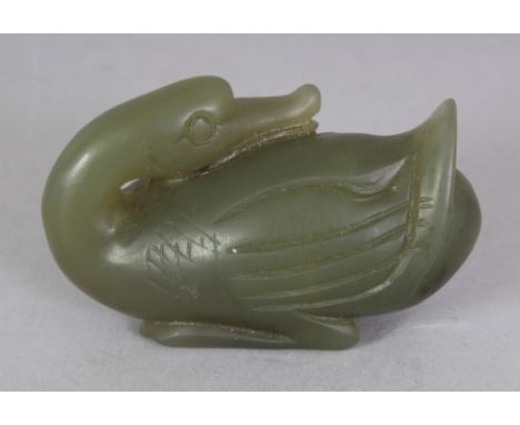 A CHINESE GREEN JADE-LIKE HARDSTONE MODEL OF A DUCK, 2in long.