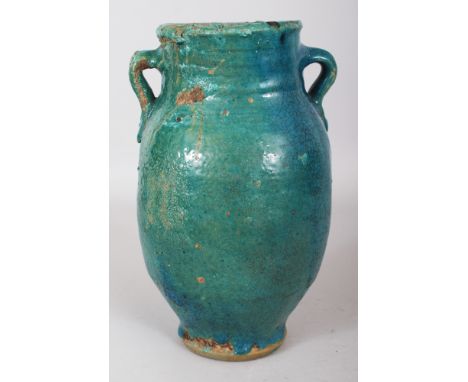 A PERSIAN TURQUOISE GLAZED CERAMIC VASE, 19th Century or earlier, the neck with double lug handles, 10.75in high.