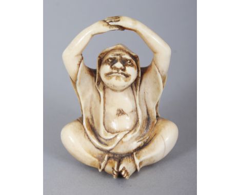 A SIGNED JAPANESE MEIJI PERIOD IVORY NETSUKE OF DARUMA, seated and with his raised arms forming the himotoshi, the base with 