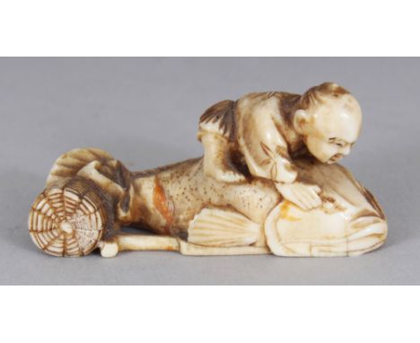 A JAPANESE MEIJI PERIOD CARVED IVORY NETSUKE OF A MAN RIDING A CARP, possibly Ebisu, 1.75in long.