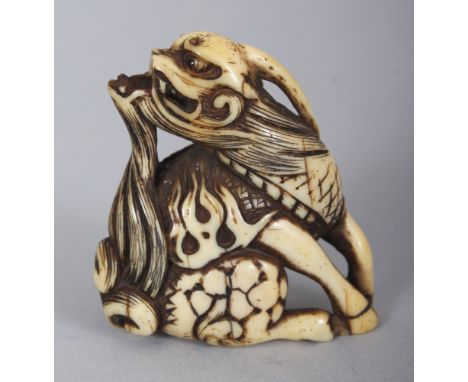 A SIGNED JAPANESE EDO PERIOD IVORY NETSUKE OF A QILIN, the base with an engraved signature, 1.8in high.