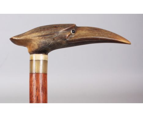 A HORN HANDLED WOOD WALKING STICK, with a sectional horn collar, the handle carved in the form of a bird’s head, the horn pos