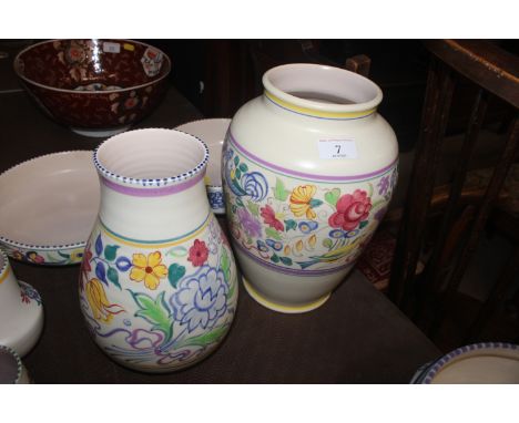 A large Poole pottery baluster vase with blue and yellow bird decoration; and a smaller vase with flowerhead decoration