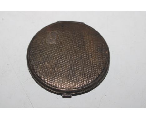 A circular silver compact with engine turned decoration, Hallmarked Birmingham 1941, maker William Suckling Ltd.