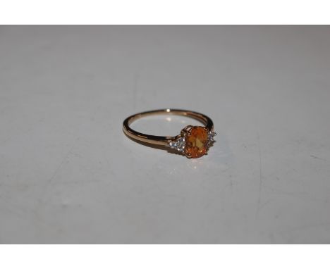 A 9ct gold ring set with citrine coloured and white stones, approx. total weight 1.5gms, ring size P/Q