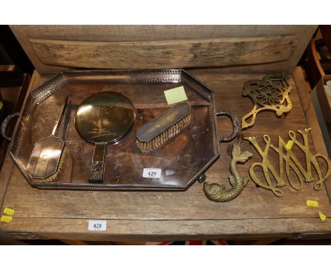 A plated two handled tea tray; two plated hair brushes; a hand mirror; brass ware; dolphin door knocker etc. 