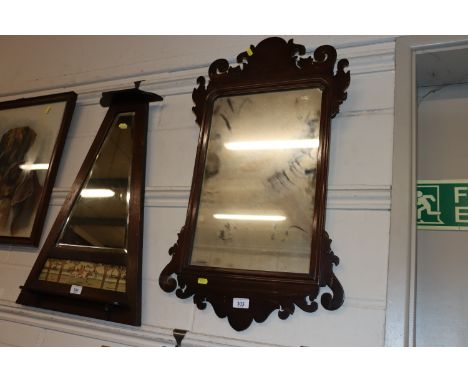 A mahogany framed Chippendale style fret carved wall mirror 