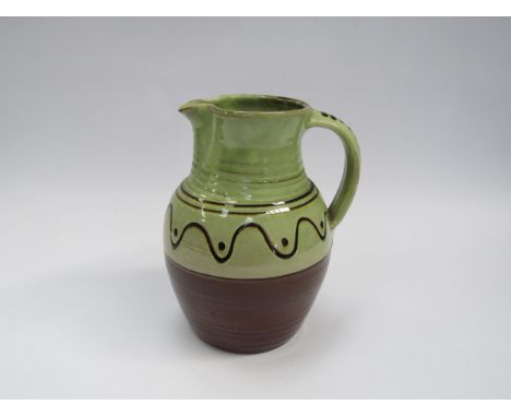 A Winchcombe Pottery large jug, green glazed upper section with slip detail. Impressed mark to base, 23.5cm high 