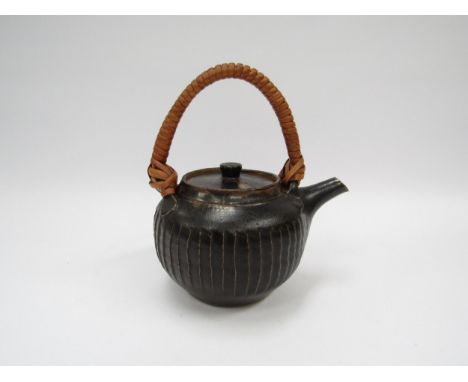 A St. Ives Leach Pottery tea pot, cut sided detail with tenmoku glaze and cane handle. Pottery and personal marks for Scott M