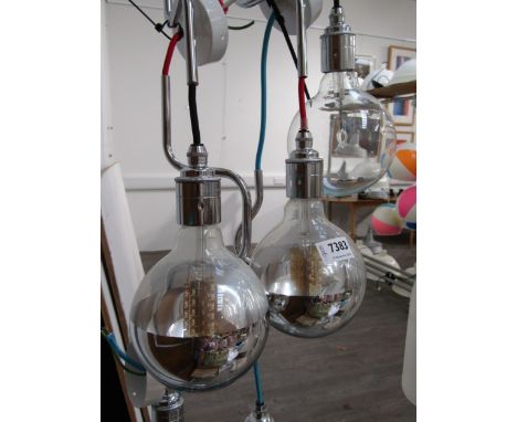 A set of six globe lights with three half chromed shades, three clear and chromed fittings 
