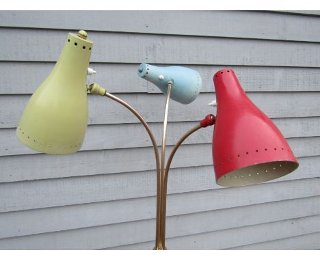 A 1950's standard lamp, red base with three brassed metal supports, red blue and yellow adjustable shades 155cm tall 