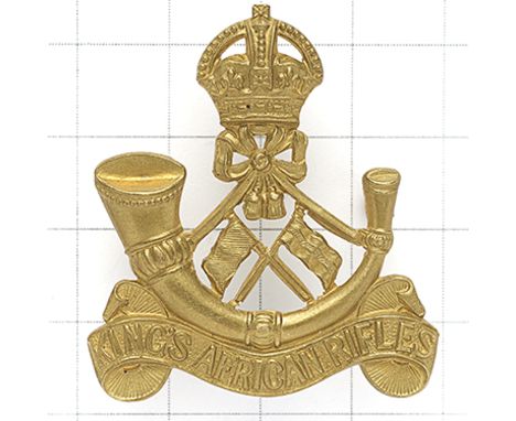 King’s African Rifles Signal Section pre 1952 brass cap badge. Die-cast crowned strung bugle on title scroll, crossed flags t