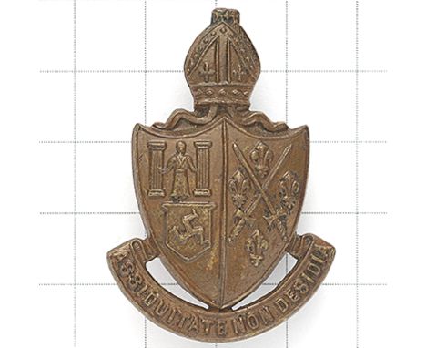 King William’s College Isle of Man OTC bronze cap badge. Cast Mitred College shield on motto “ASSIDUITATE  NON DESIDIA”  Blad