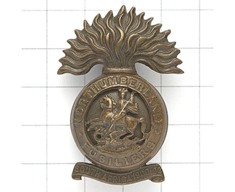 4th, 5th &amp; 6th Bns. Northumberland Fusiliers post 1908 OSD cap badge. Scarce die-cast bronze example with “SOUTH AFRICA 1