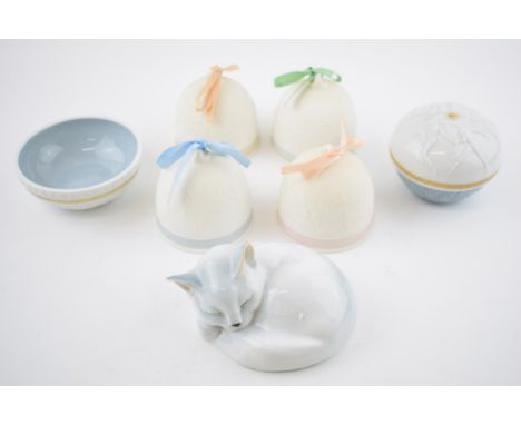A collection of Lladro Christmas bells in varying colours with moulded decoration, with Lladro trinket parts and a German pot