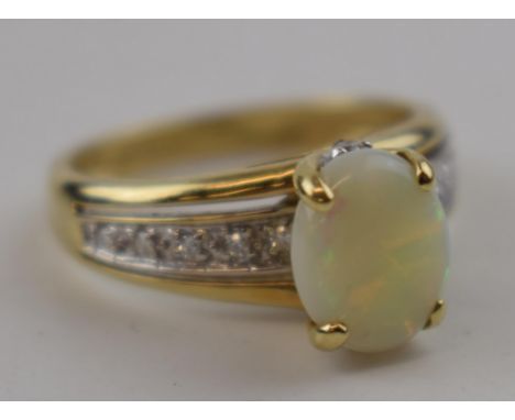 9ct gold ring with large central opal and illusion set diamond shoulders, 2.9 grams, size M.  