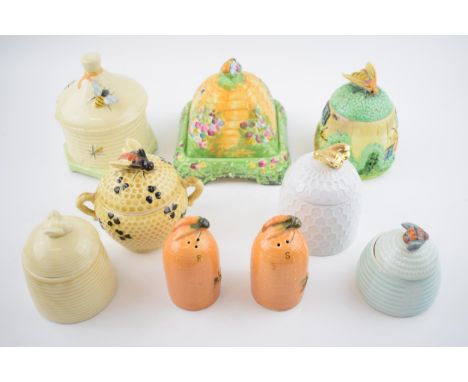 A collection of pottery honey pots in varying forms and colours to include a Cottage Ware example, Royal Winton Grimwades, Sh