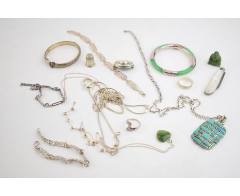A collection of silver jewellery to include necklaces, a heavy turqouise style pendant, a Jade (or similar) silver bangle and