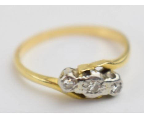 Yellow metal (tests as 18ct gold) and diamond crossover ring, size M, 2.2 grams.  