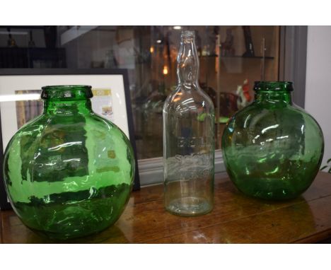 A pair of large Viresa green glass carboys, 35cm tall, together with a Bells Scotch Whisky bottle (3).  Condition is generall